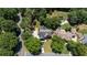 Aerial view of a home with a pool surrounded by mature trees and landscaping at 161 Forestview Dr, Suwanee, GA 30024