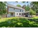 Backyard view featuring a covered patio and landscaped yard with lush green grass at 161 Forestview Dr, Suwanee, GA 30024