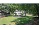 Large backyard features swing set, manicured lawn and view of the home at 161 Forestview Dr, Suwanee, GA 30024