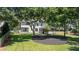 Expansive backyard with lush lawn, mature trees and swing set at 161 Forestview Dr, Suwanee, GA 30024