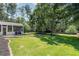Lush backyard with mature trees, swing set and grill, creating a perfect outdoor oasis at 161 Forestview Dr, Suwanee, GA 30024