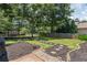 Serene backyard features a swing set with stone walkway and manicured landscaping at 161 Forestview Dr, Suwanee, GA 30024