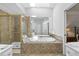 Bright bathroom with a shower, jetted tub, and a skylight bringing in natural light at 161 Forestview Dr, Suwanee, GA 30024