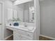 Bright bathroom with vanity, white countertops, large mirror, and built-in storage at 161 Forestview Dr, Suwanee, GA 30024