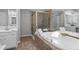 Luxurious bathroom featuring a jetted tub and separate shower with elegant glass doors at 161 Forestview Dr, Suwanee, GA 30024