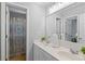 Bright bathroom featuring double sinks, a large mirror, and a shower with colorful curtain at 161 Forestview Dr, Suwanee, GA 30024