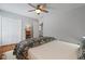 Cozy bedroom features hardwood floors, a ceiling fan, and a double door closet at 161 Forestview Dr, Suwanee, GA 30024