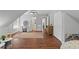 Spacious room featuring sloped ceilings, hardwood floors, and a desk with vanity area at 161 Forestview Dr, Suwanee, GA 30024