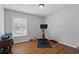 Well-lit exercise room with hardwood floors, a stationary bike, and free weights at 161 Forestview Dr, Suwanee, GA 30024