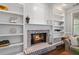 Close-up of the brick fireplace with white built-in shelves, adding charm to the living space at 161 Forestview Dr, Suwanee, GA 30024