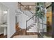Elegant foyer with hardwood floors, staircase, and views into other rooms at 161 Forestview Dr, Suwanee, GA 30024