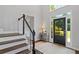 Foyer featuring staircase, dark wood floors, and large front door with windows at 161 Forestview Dr, Suwanee, GA 30024