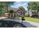 Charming brick two-story home featuring mature trees and lush landscaping at 161 Forestview Dr, Suwanee, GA 30024