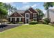 Beautiful brick home with a well-manicured lawn and landscaping, highlighting the property's curb appeal at 161 Forestview Dr, Suwanee, GA 30024