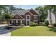 Charming brick two-story home with well-manicured lawn and lush landscaping at 161 Forestview Dr, Suwanee, GA 30024