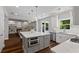 Modern kitchen with white cabinetry, stainless steel appliances, and a large center island at 161 Forestview Dr, Suwanee, GA 30024