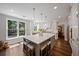 Lovely kitchen features a white island, hardwood floors, and stainless appliances at 161 Forestview Dr, Suwanee, GA 30024