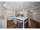 Spacious kitchen with white cabinets, large island, and seating, perfect for entertaining at 161 Forestview Dr, Suwanee, GA 30024