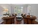 Cozy sitting area with leather chairs arranged around a dark table; features bright natural light at 161 Forestview Dr, Suwanee, GA 30024