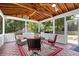 Inviting sunroom featuring tile floors, wood ceilings, and scenic backyard views at 161 Forestview Dr, Suwanee, GA 30024
