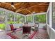 Bright sunroom with tile floors, wood ceilings, and views of the private wooded yard at 161 Forestview Dr, Suwanee, GA 30024
