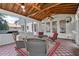 Cozy screened-in porch boasts wood ceiling, tile floor and walls of screened windows at 161 Forestview Dr, Suwanee, GA 30024