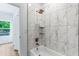 Stylish bathroom featuring a tub with marble tile surround, and modern fixtures at 1835 Taylor Ave, East Point, GA 30344