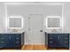 Modern bathroom featuring dual vanities with marble countertops and backlit mirrors at 1835 Taylor Ave, East Point, GA 30344
