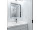 This modern bathroom features a framed mirror and chrome faucet with view of shower at 1835 Taylor Ave, East Point, GA 30344
