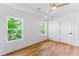 Clean bedroom with wood floors, two large windows and bright lighting at 1835 Taylor Ave, East Point, GA 30344