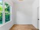 Bright bedroom features hardwood floors, white walls, and a large window providing natural light at 1835 Taylor Ave, East Point, GA 30344