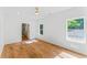 Spacious bedroom with wood floors, three windows, and ensuite bathroom at 1835 Taylor Ave, East Point, GA 30344