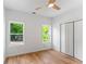 Bright bedroom with wood floors, two windows, and a closet at 1835 Taylor Ave, East Point, GA 30344