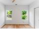 This spacious bedroom offers hardwood floors, two large windows, and a ceiling fan at 1835 Taylor Ave, East Point, GA 30344