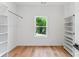 Bright walk-in closet with custom shelving and wood floor at 1835 Taylor Ave, East Point, GA 30344