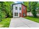 Modern two-story home with a concrete driveway and a mix of gray and red siding at 1835 Taylor Ave, East Point, GA 30344