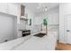 Well-lit kitchen with granite countertops, white cabinets, stainless steel appliances, and a spacious center island at 1835 Taylor Ave, East Point, GA 30344