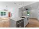 Open-concept kitchen with white marble island, stainless steel appliances, and lots of natural light at 1835 Taylor Ave, East Point, GA 30344