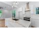 Stylish kitchen with white cabinets, stainless steel appliances, and a central island with marble countertop at 1835 Taylor Ave, East Point, GA 30344