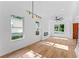 Bright living room with hardwood floors, modern lighting, and views of the outdoors at 1835 Taylor Ave, East Point, GA 30344
