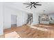 Open-concept living space with hardwood floors and access to the staircase, kitchen, and backyard at 1835 Taylor Ave, East Point, GA 30344