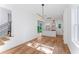 Open-concept living space showcasing hardwood floors and access to the modern kitchen and backyard at 1835 Taylor Ave, East Point, GA 30344