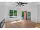 Sun-filled living room with hardwood floors, a stylish ceiling fan, and a modern fireplace at 1835 Taylor Ave, East Point, GA 30344