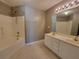 Well-lit bathroom featuring a double sink vanity and shower-tub combination at 285 Fieldview Ln, Covington, GA 30016