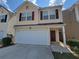 Inviting two-story home featuring a two-car garage and cozy front porch at 285 Fieldview Ln, Covington, GA 30016