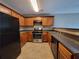 Kitchen with dark cabinets, stainless steel appliances, and tile flooring at 285 Fieldview Ln, Covington, GA 30016