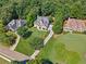 Aerial view of the home nestled on a large lot with manicured landscaping and a curved driveway at 3845 Overlake Dr, Cumming, GA 30041