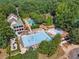 Aerial view of community pool surrounded by lush landscaping and mature trees at 3845 Overlake Dr, Cumming, GA 30041