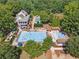 Community pool from above featuring a large sundeck, lounge chairs, and umbrellas at 3845 Overlake Dr, Cumming, GA 30041