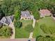 Beautiful aerial shot showcasing the home's placement on a meticulously landscaped lot with mature trees at 3845 Overlake Dr, Cumming, GA 30041